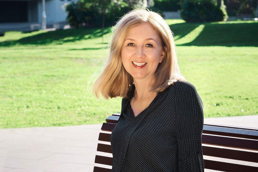 A woman sits on a bench