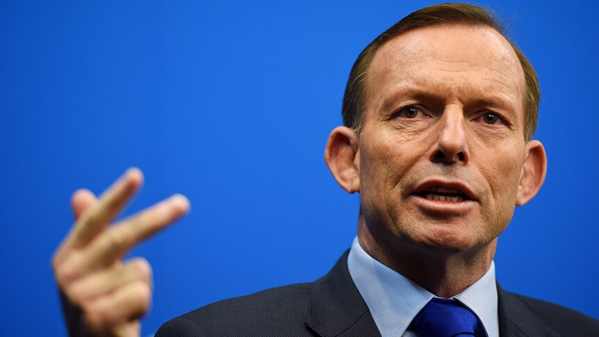Prime Minister Tony Abbott holds up his hand while speaking