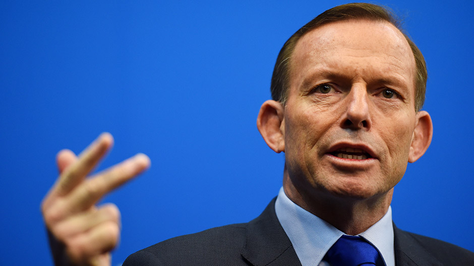 Prime Minister Tony Abbott holds up his hand while speaking