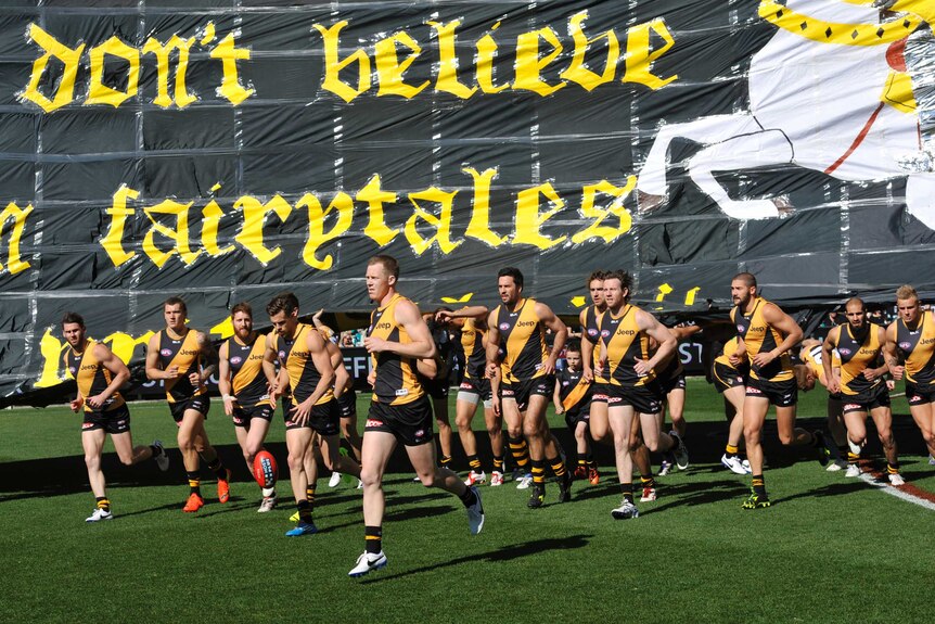 Richmond players run onto the field during the elimination final against Port Adelaide in 2014.