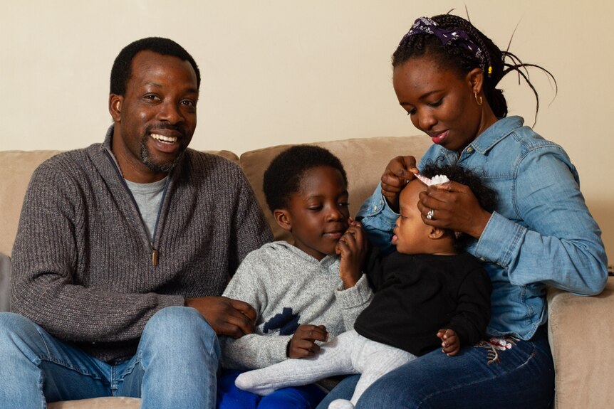 Ola and Shola Tawose with their son Midola and daughter Hazel in their home in Orange, NSW