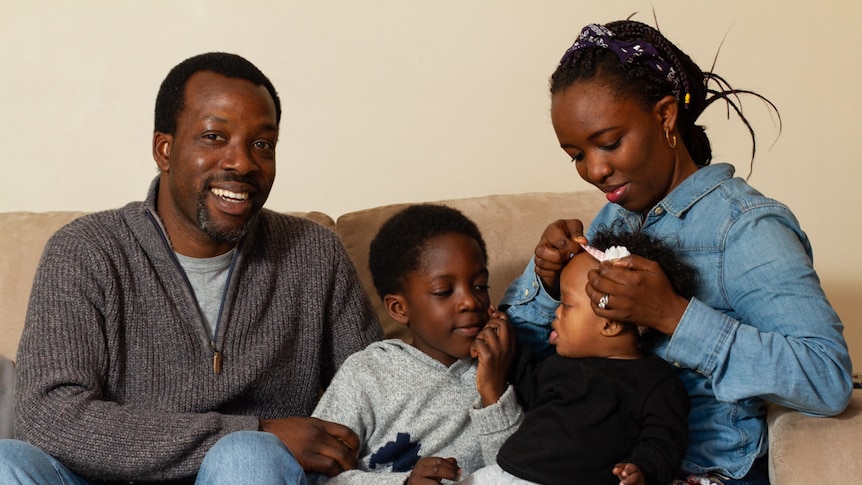 Ola Tawose and his wife Shola with their son Midola and daughter Hazel in their home in Orange, NSW