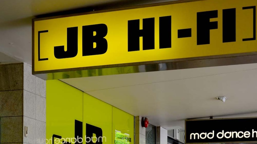 A photo of a JB Hi-Fi storefront with people walking past