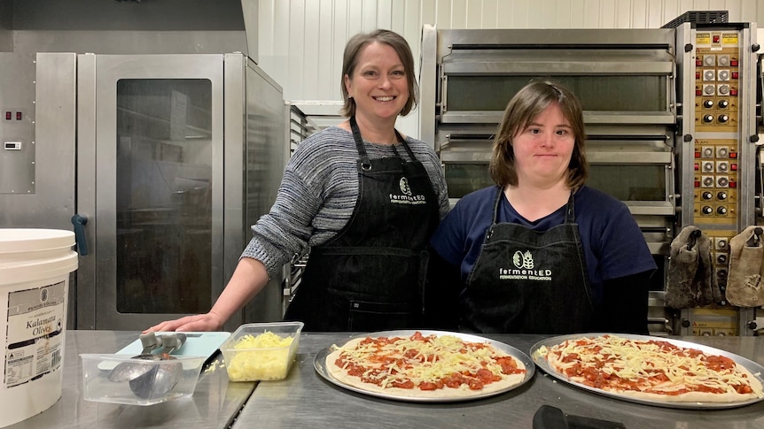Sarah with her support worker and their freshly made pizzas.