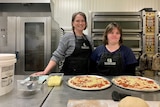 Sarah with her support worker and their freshly made pizzas.