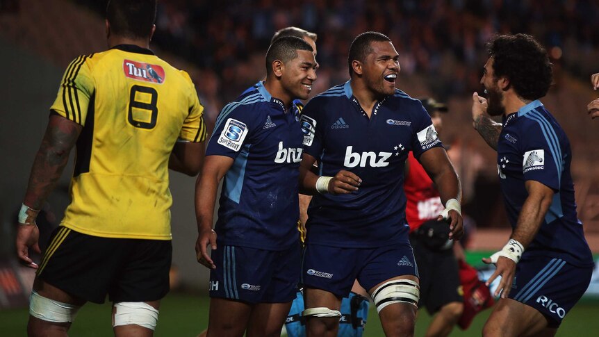 Just too good ... Charles Piutau celebrates with Peter Saili and Rene Ranger after scoring for the Blues.