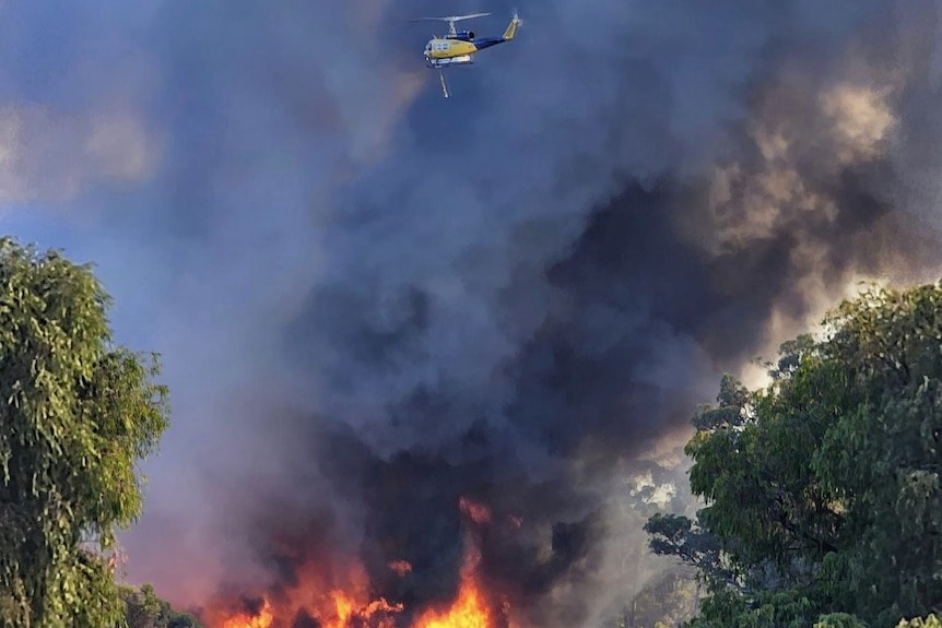A helicopter helping put out a fire