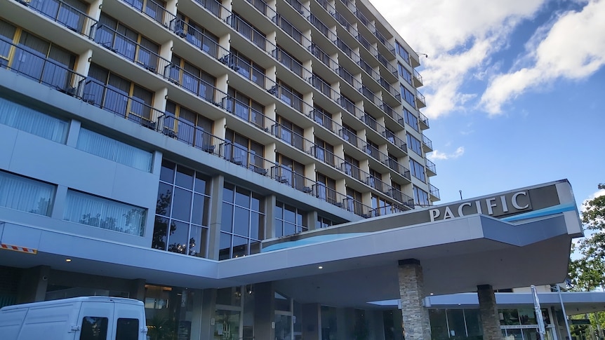 A highrise hotel with many balconies and "Pacific" on the awning