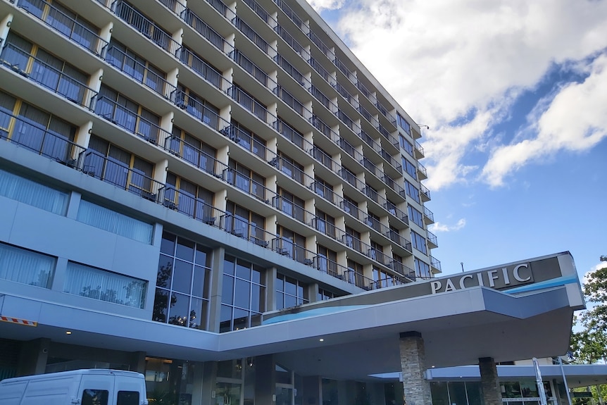 A highrise hotel with many balconies and "Pacific" on the awning