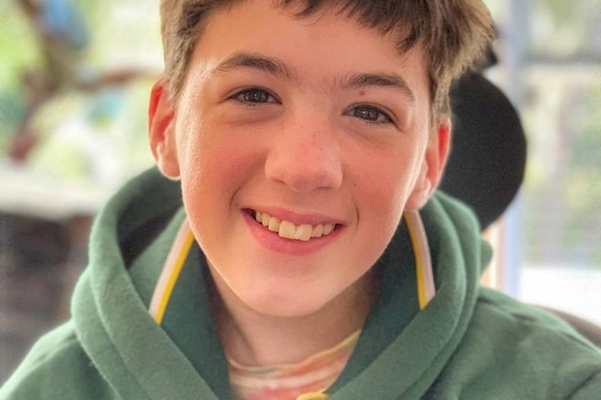 Portrait of a teenage boy in a green hoodie
