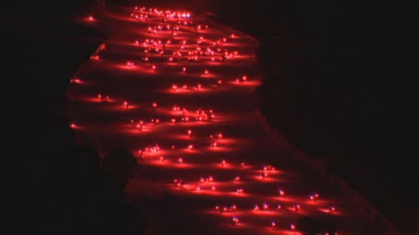 Skiers use flares to light up the slopes at Thredbo.