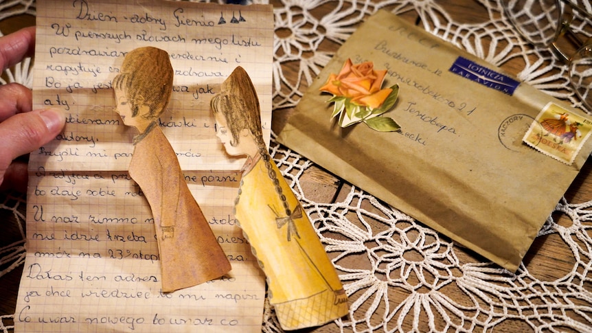 A view of an old letter and paper dolls.