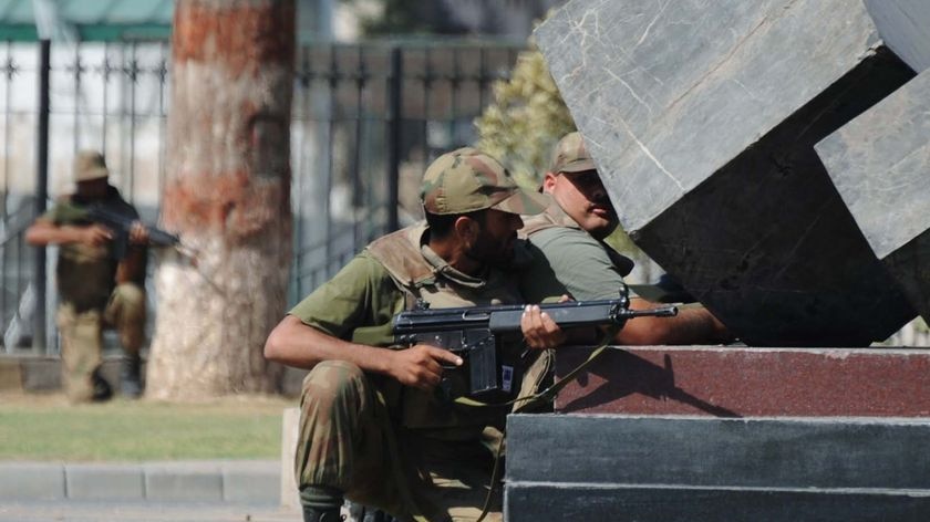 Pakistani soldiers take cover during an attack on the main army base by Taliban militants.