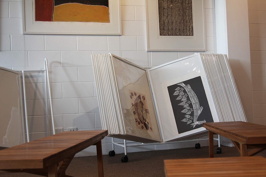 A photo of a book of artworks open near some benches in Provenance Arts.