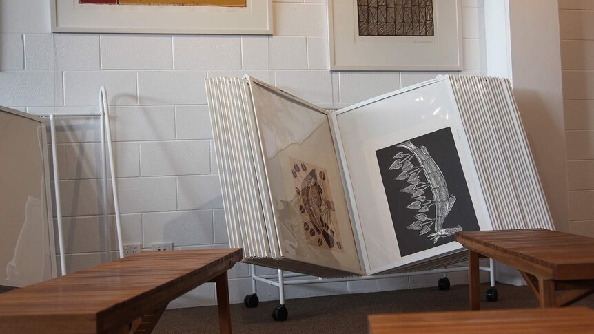 A photo of a book of artworks open near some benches in Provenance Arts.