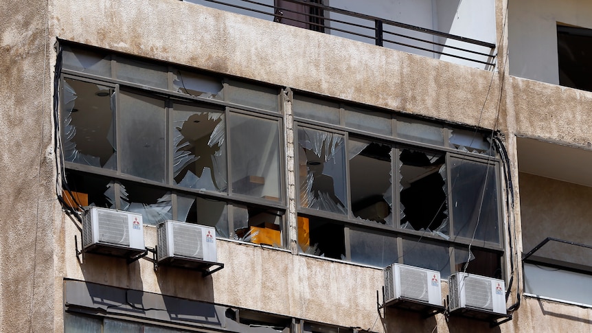 Broken windows and damage to a building.