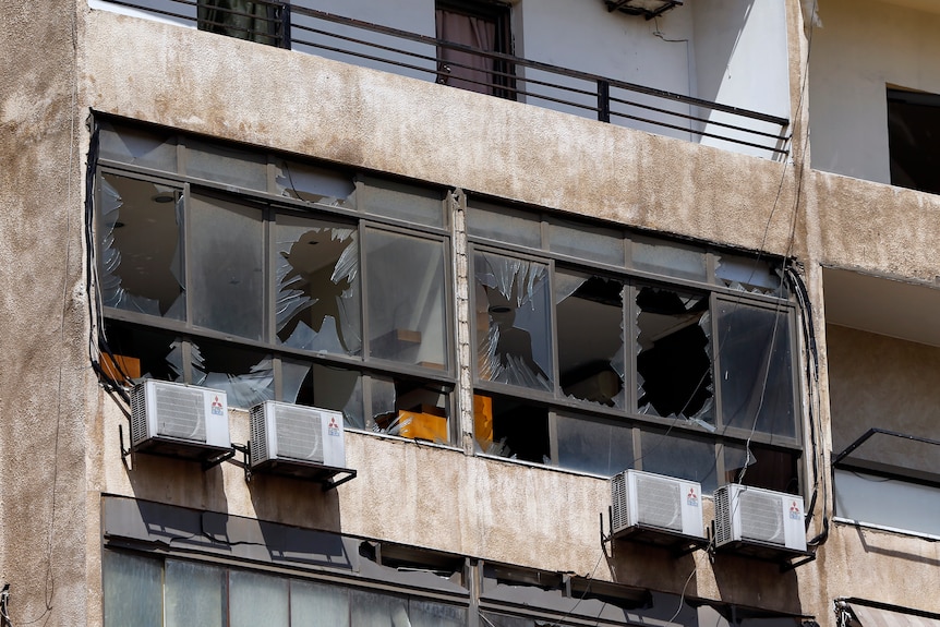 Broken windows and damage to a building.