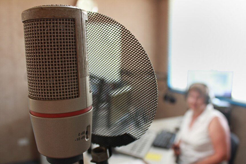 Microphone close up, Ms Burgum in the background.