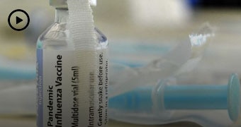 A vaccine bottle and syringe.