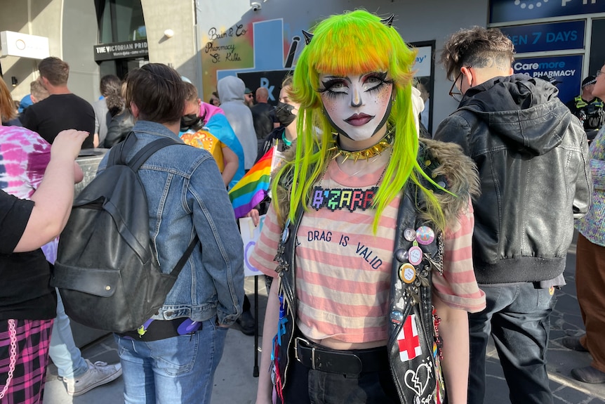 A drag artist looking at the camera outside the Victorian Pride Centre in St Kilda.