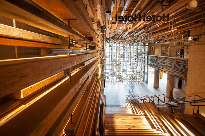 Wood detailing on a grand staircase inside a hotel.