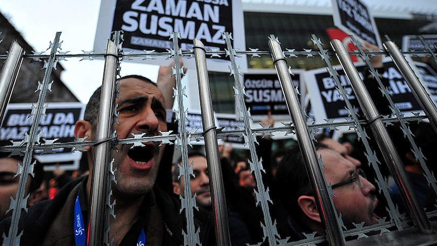 Staff members and supporters of Zaman newspaper protest against a raid by counter-terror police in Istanbul on December 14, 2014.