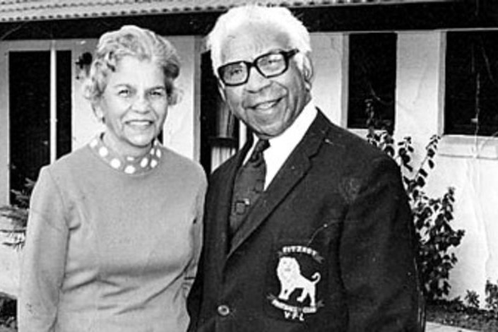 A black and white photo showing an elderly, formally dressed Aboriginal couple.