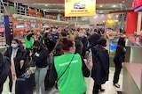 Passengers queue at Sydney Airport
