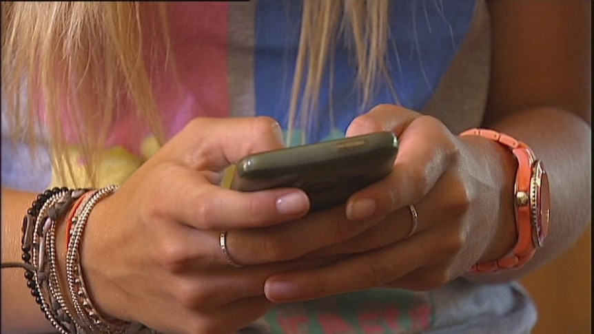 A young person using a mobile phone.