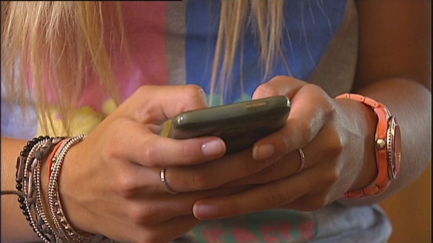 A young woman texting on a mobile phone