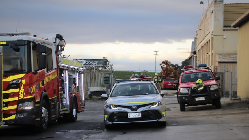 Police and fire crews outside a factory.