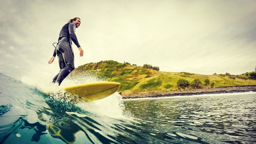 Smiling man on surfboard