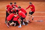 Belgium's Davis Cup team piles on after beating Australia.