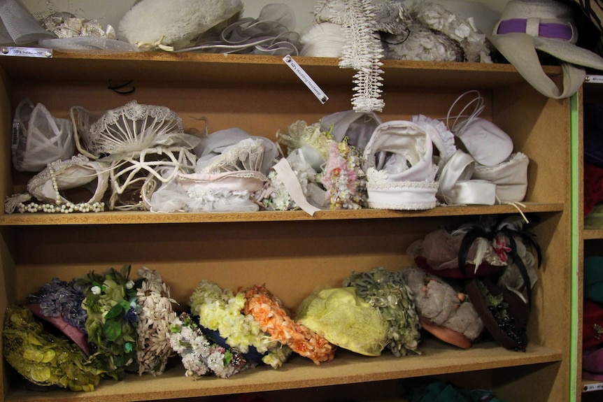 1960s bridal hats on some wooden shelves.