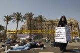 A protester in Tahrir Square demands the ouster of all those associated with the former regime.