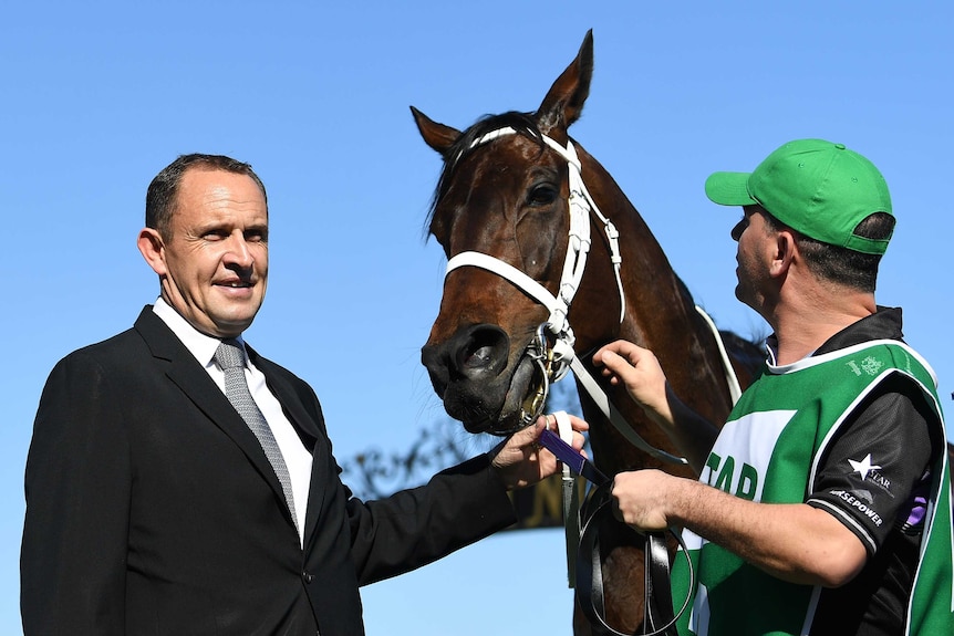 Trainer Chris Waller (L) with Winx after the Turnbull Stakes at Flemington on October 6, 2018.