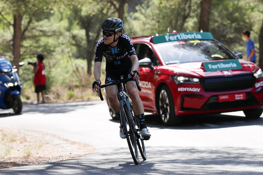 Michael Storer grimaces as he rides around a corner