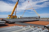 The Northern Gas Pipeline being stockpiled in Tennant Creek