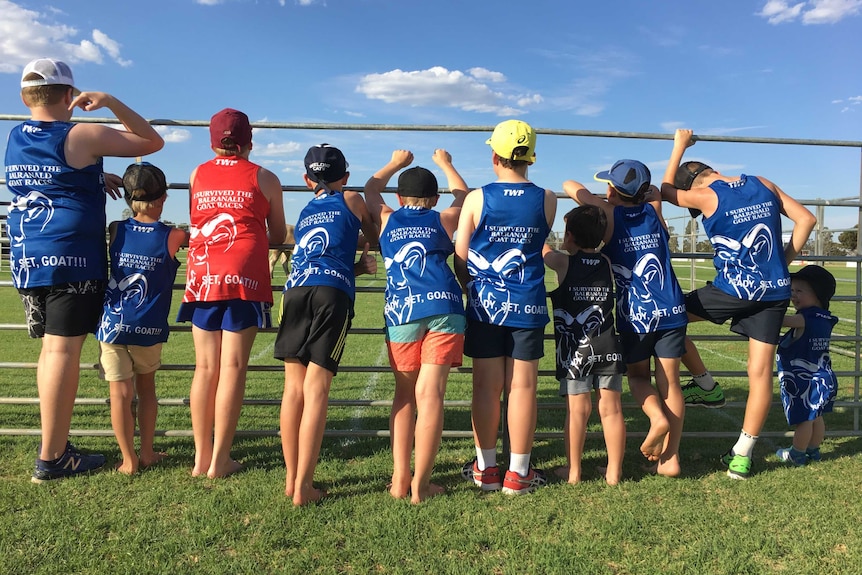 Young attendees in event shirts.