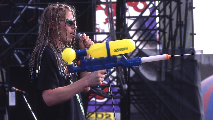 Member of The Offspring sprays a water pistol into the crowd at Big Day Out 1995