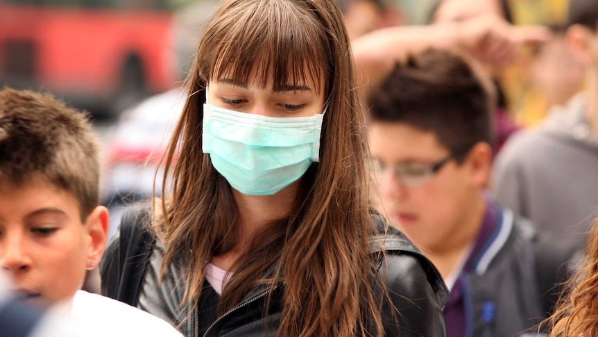 A woman wearing a surgical mask to prevent the transmission of airborne infection