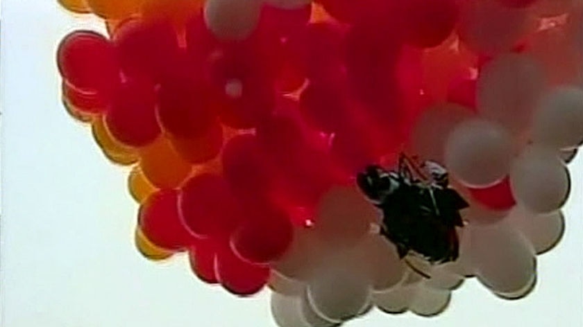 Brazilian priest suspended under helium-filled party balloons