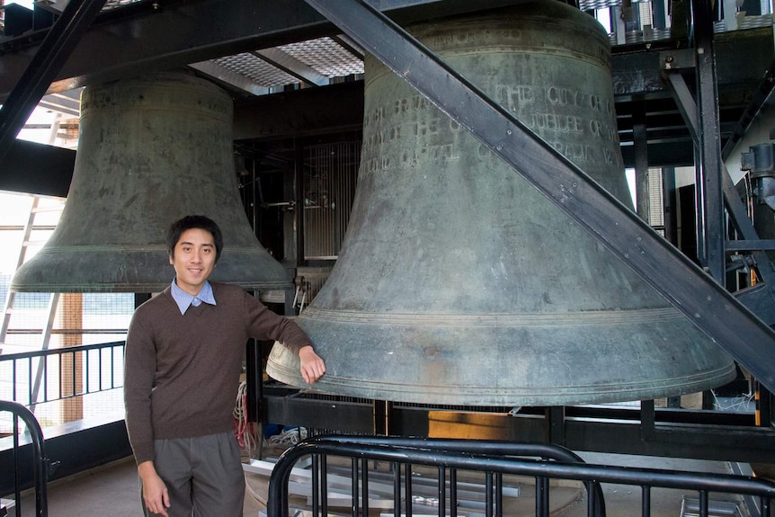 Carillonist Thomas Laue beside bells
