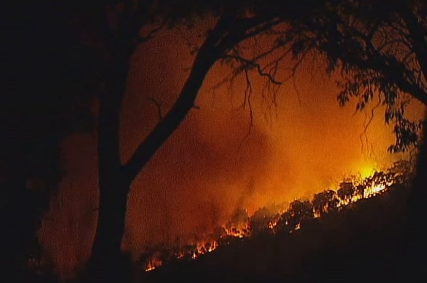 Glowing flames from the Longwood East fire on Tuesday night near Ruffy, Victoria.