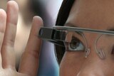 A woman tries on Google eyewear, Google Glass