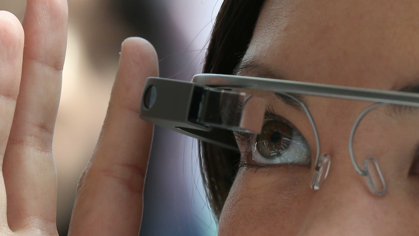 A woman tries on Google eyewear, Google Glass