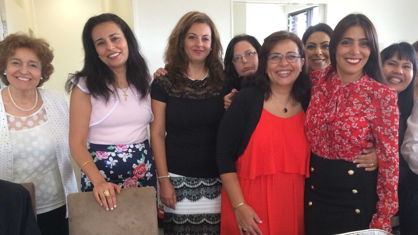 Coptic Christians in the Manning share Egyptian food after the Cundletown church's opening.