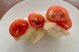 Tomato with ice cream on a plate
