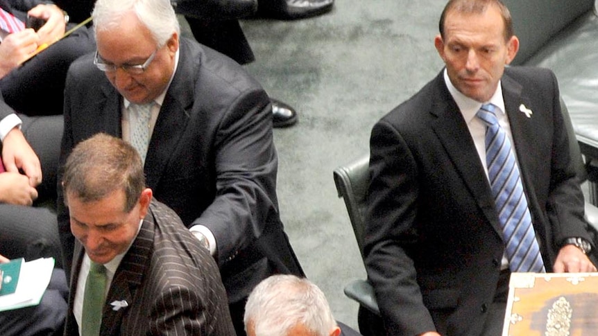 Tony Abbott watches Pater Slipper being taken to the Speaker's chair.