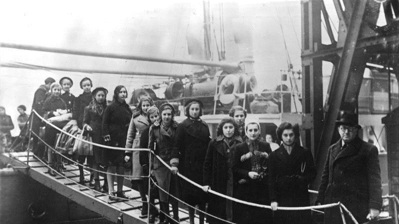 A group of young Jews stand on a drawbridge on a ship docked in London after being evacuated from Germany and Poland.